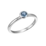 White gold ring with blue topaz in a button setting