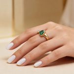 Gold ring with diamonds and emeralds