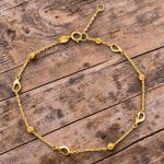 Thin gold bracelet with heart decorations
