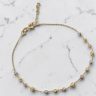 Thin gold bracelet with engraved tricolor spheres