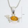 Silver dog pendant with amber dachshund