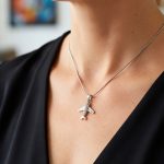 Silver airplane pendant with zirconia stones