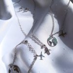 Silver airplane pendant with zirconia stones