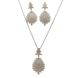   Silver jewelry set with pendant and earrings featuring a floral pattern and zirconia stones