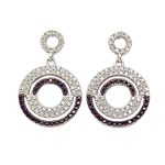 Silver jewelry set with pendant and earrings featuring black and white zirconia