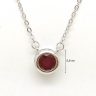 Silver necklace with ruby in a button setting