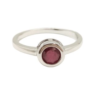Silver ring with ruby stone in a button setting