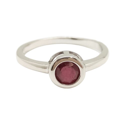 Silver ring with ruby stone in a button setting