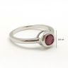 Silver ring with ruby stone in a button setting