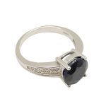 Silver ring with large blue sapphire stone and zirconia crystals