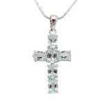 Silver cross pendant with genuine blue topaz