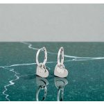 Small silver hoop earrings with dangling hearts