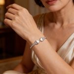 Silver open bangle with mother-of-pearl heart