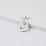 Silver pendant with the letter G