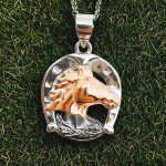 Silver horseshoe pendant with rose gold horse