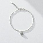 Thin silver bracelet with lotus flower pendant