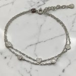 Double silver bracelet with stones and a heart