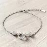   Elegáns ezüst karkötő egymásba fonódó karika medállal