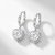 Silver hoop earrings with sparkling zirconia hearts