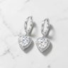 Silver hoop earrings with sparkling zirconia hearts