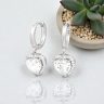 Silver hoop earrings with sparkling zirconia hearts