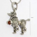 Antique silver dog pendant with amber